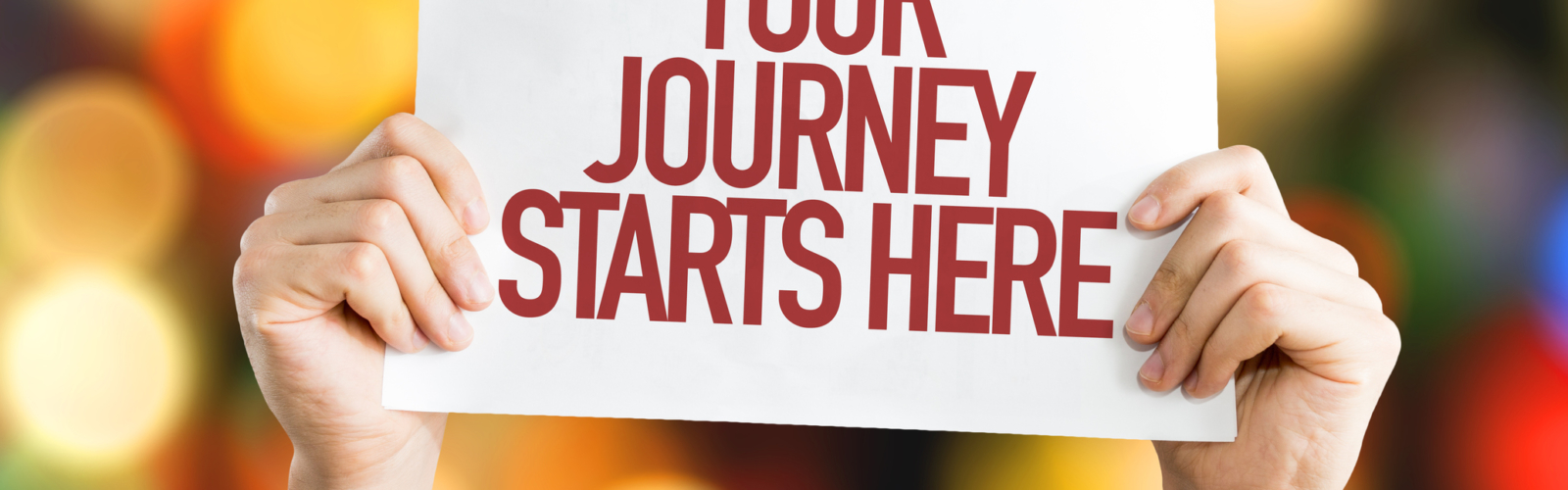 Your Journey Starts Here placard with bokeh background